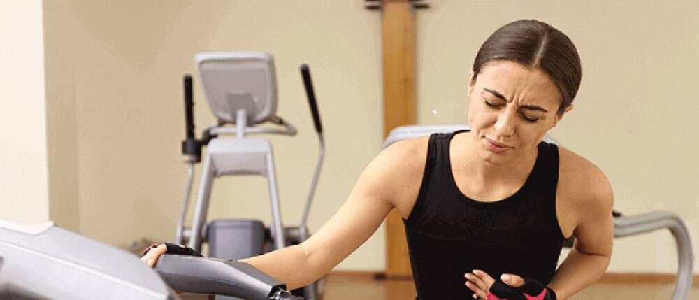 Premium Photo  Young woman working out in gym using gym equipment